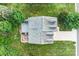 Aerial view of the house featuring the roof, backyard, patio, wooden deck, and green trees at 1503 Stoney Ct, York, SC 29745