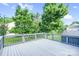Wide backyard view of the wooden deck showing the railing and the green trees around it at 1503 Stoney Ct, York, SC 29745