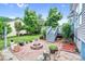 View of backyard firepit with patio, green trees, and wood stairs from the wooden deck at 1503 Stoney Ct, York, SC 29745
