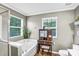 Bathroom view showcasing tub, glass shower, vanity with seat, and natural light from windows at 1503 Stoney Ct, York, SC 29745