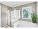 Bright bathroom featuring a garden tub, glass shower, and natural light from the window at 1503 Stoney Ct, York, SC 29745