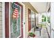 Inviting front porch with seating area and an American themed decorative door at 1503 Stoney Ct, York, SC 29745