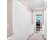 Hallway with neutral paint, white trim, and closet with six-panel doors offers transition to rooms at 1503 Stoney Ct, York, SC 29745