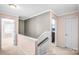 Upstairs hallway with neutral paint, wall to wall carpet, and views into multiple bedrooms at 1503 Stoney Ct, York, SC 29745