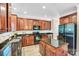 Updated kitchen featuring stainless steel appliances, granite countertops, and wood cabinets at 1503 Stoney Ct, York, SC 29745