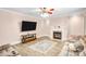 Cozy living room with a fireplace, large TV, beige walls, neutral furniture, and wood-look floors at 1503 Stoney Ct, York, SC 29745