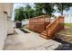 Backyard area featuring a wooden deck with stairs, a small storage shed, and a paved walkway at 1776 Baylor Dr, Rock Hill, SC 29732