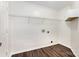 Laundry room with white walls, wooden-style floors, wire rack and a white cabinet for organizing laundry essentials at 1776 Baylor Dr, Rock Hill, SC 29732