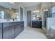 Bright bathroom features dual vanities, large mirrors, and a glass-enclosed shower at 18145 Sulton Ter, Huntersville, NC 28078