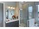 Well-lit bathroom showcasing a glass shower, vanity with double sinks and decor at 18145 Sulton Ter, Huntersville, NC 28078