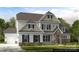 Charming two-story home features a stone entryway, white siding, black shutters, and a well-manicured lawn at 18145 Sulton Ter, Huntersville, NC 28078