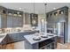 Modern kitchen features gray cabinets, stainless steel appliances, a spacious island and stylish pendant lighting at 18145 Sulton Ter, Huntersville, NC 28078