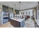 Bright, open kitchen with stainless steel appliances, a large island, and seamless access to the dining and living areas at 18145 Sulton Ter, Huntersville, NC 28078