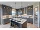 Stylish kitchen featuring gray cabinets, a center island with seating, stainless steel appliances, and pendant lighting at 18145 Sulton Ter, Huntersville, NC 28078