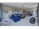 Spacious living room with blue sectional sofa, gaming area, custom shelving, and comfortable seating at 18145 Sulton Ter, Huntersville, NC 28078