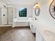 Bright bathroom featuring a shower, soaking tub, and double sink vanity with decorative mirrors at 18414 Victoria Bay Dr, Cornelius, NC 28031