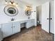 Bright bathroom with double sinks, ornate mirrors, and ample counter space at 18414 Victoria Bay Dr, Cornelius, NC 28031