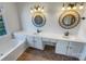 Well-lit bathroom featuring double sinks and a tub at 18414 Victoria Bay Dr, Cornelius, NC 28031