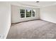 Spacious bedroom with large windows and tray ceiling, offering natural light at 18414 Victoria Bay Dr, Cornelius, NC 28031