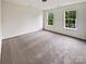 Bright bedroom features neutral carpet, two windows, and ample natural light at 18414 Victoria Bay Dr, Cornelius, NC 28031