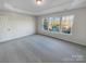 Bright bedroom with large windows and tray ceiling, offering plenty of natural light at 18414 Victoria Bay Dr, Cornelius, NC 28031