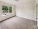 Bedroom with carpeted floor and one window offering neighborhood views at 18414 Victoria Bay Dr, Cornelius, NC 28031