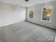 Bright bedroom with neutral carpet, natural light, and ample space at 18414 Victoria Bay Dr, Cornelius, NC 28031