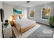 Staged primary bedroom with calming decor, and natural light from windows at 18414 Victoria Bay Dr, Cornelius, NC 28031