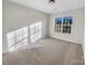 Well-lit bedroom with neutral carpet and a large window at 18414 Victoria Bay Dr, Cornelius, NC 28031