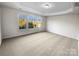 Spacious carpeted bedroom with ample sunlight and scenic outdoor views at 18414 Victoria Bay Dr, Cornelius, NC 28031