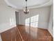 Elegant dining room with hardwood floors, wainscoting, and a decorative chandelier at 18414 Victoria Bay Dr, Cornelius, NC 28031