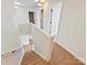 Upstairs hallway with carpet, and white trim leading to bedrooms at 18414 Victoria Bay Dr, Cornelius, NC 28031