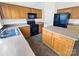 This kitchen features wood cabinets, black appliances and a kitchen island at 18414 Victoria Bay Dr, Cornelius, NC 28031