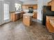 Well-lit kitchen featuring an island, lots of counter space, and a door to the outside at 18414 Victoria Bay Dr, Cornelius, NC 28031
