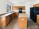 Kitchen featuring wood cabinets, black appliances, and a center island at 18414 Victoria Bay Dr, Cornelius, NC 28031