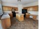Spacious kitchen with an island, ample cabinet storage, and modern black appliances at 18414 Victoria Bay Dr, Cornelius, NC 28031