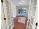 Living room with hardwood floors, large windows, and a glass paneled door at 18414 Victoria Bay Dr, Cornelius, NC 28031