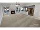 Bright and spacious living room featuring a fireplace, neutral carpeting, and an open floor plan at 18414 Victoria Bay Dr, Cornelius, NC 28031