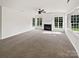 Spacious living room boasts a fireplace, ceiling fan, and multiple windows at 18414 Victoria Bay Dr, Cornelius, NC 28031