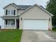 Two-story home features a two-car garage, covered porch, and neutral-colored siding at 1872 Terrain Nw Dr, Conover, NC 28613