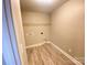 Functional laundry room featuring tile flooring, washer/dryer hookups, and overhead shelving at 1872 Terrain Nw Dr, Conover, NC 28613