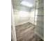 Spacious walk-in closet featuring custom shelving and modern wood-look flooring for optimal organization and storage at 1872 Terrain Nw Dr, Conover, NC 28613