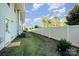 Spacious backyard with a white fence, green grass, and trees providing privacy at 2037 Langer St, Charlotte, NC 28214