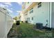 Private backyard with a white fence, green grass, and air conditioning units installed at 2037 Langer St, Charlotte, NC 28214