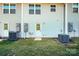 Grassy backyard area with air conditioning units and utility connections at 2037 Langer St, Charlotte, NC 28214