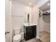 Modern bathroom with a sleek vanity, white toilet, and an open closet with ample storage space at 2037 Langer St, Charlotte, NC 28214
