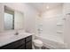 Modern bathroom with a combination shower/tub, neutral walls, and vinyl flooring at 2037 Langer St, Charlotte, NC 28214