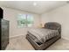 Bedroom featuring a dresser, carpeted floors, and a comfortable-looking bed with a decorative comforter at 2037 Langer St, Charlotte, NC 28214
