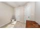 Cozy bedroom features neutral walls, carpeted floors, and a storage chair, offering a tranquil space at 2037 Langer St, Charlotte, NC 28214