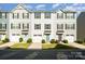 Attractive townhomes offer convenient garages, colorful doors, and neatly landscaped front yards at 2037 Langer St, Charlotte, NC 28214